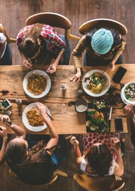 Family having lunch on a wood table